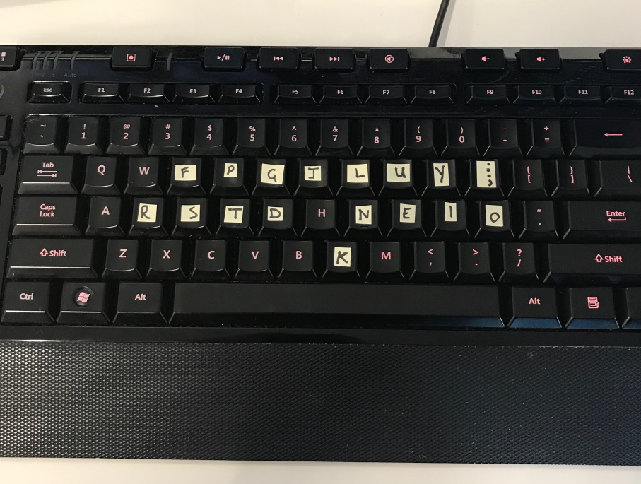 keyboard with sticky notes over the 17 colemak key position changes